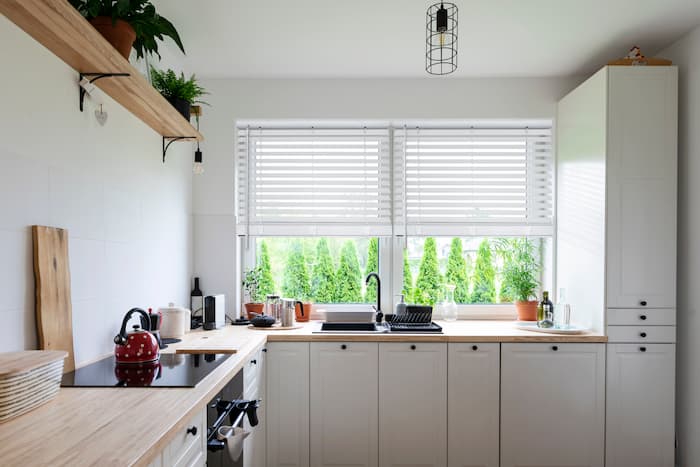 Kitchen with white blinds