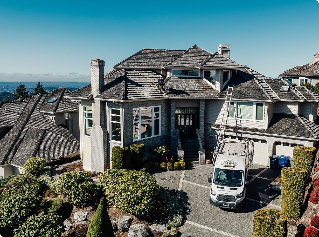 Guardian crew cleaning and maintaining a Pacific Northwest roof