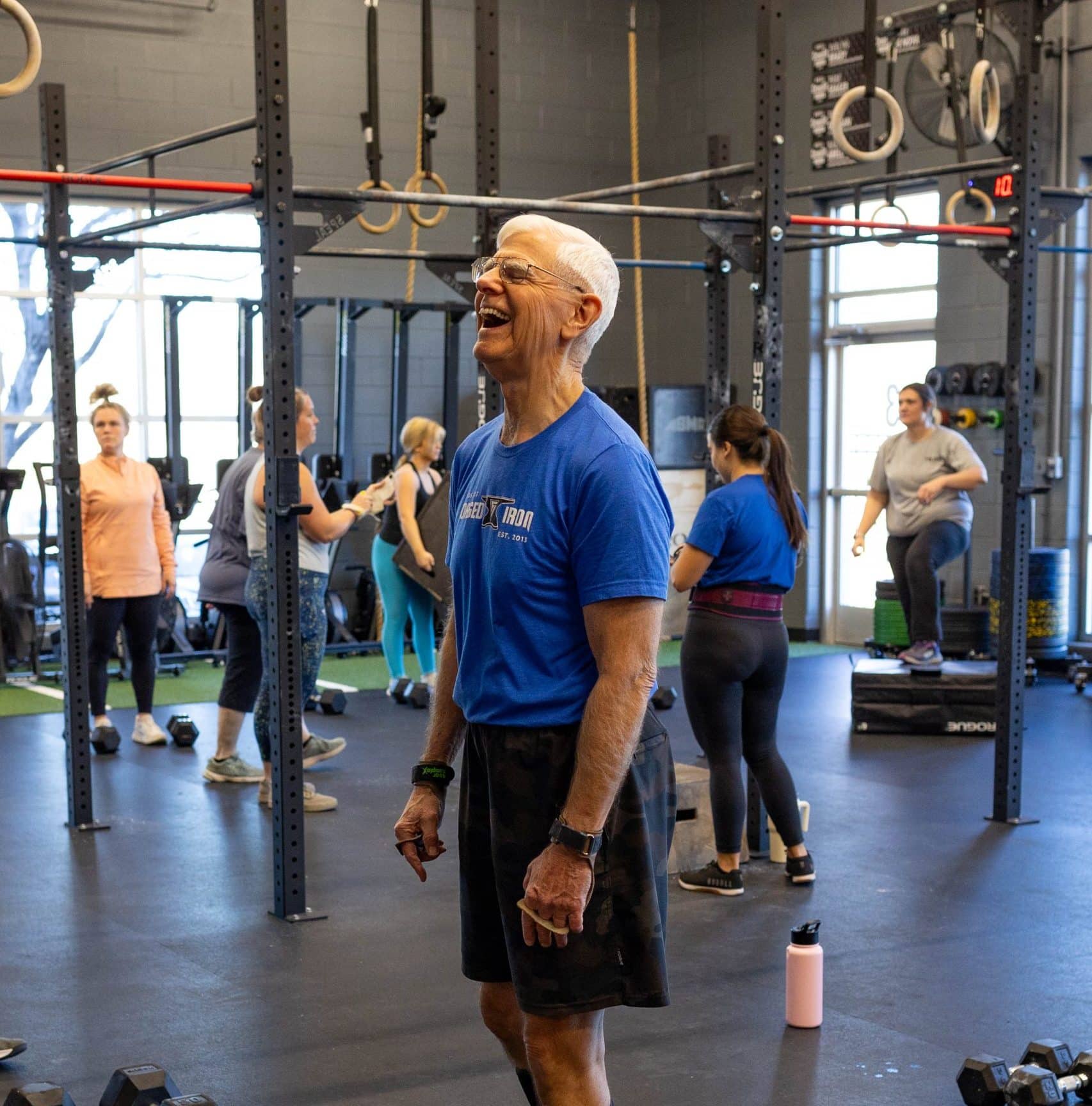 a man laughing in a gym