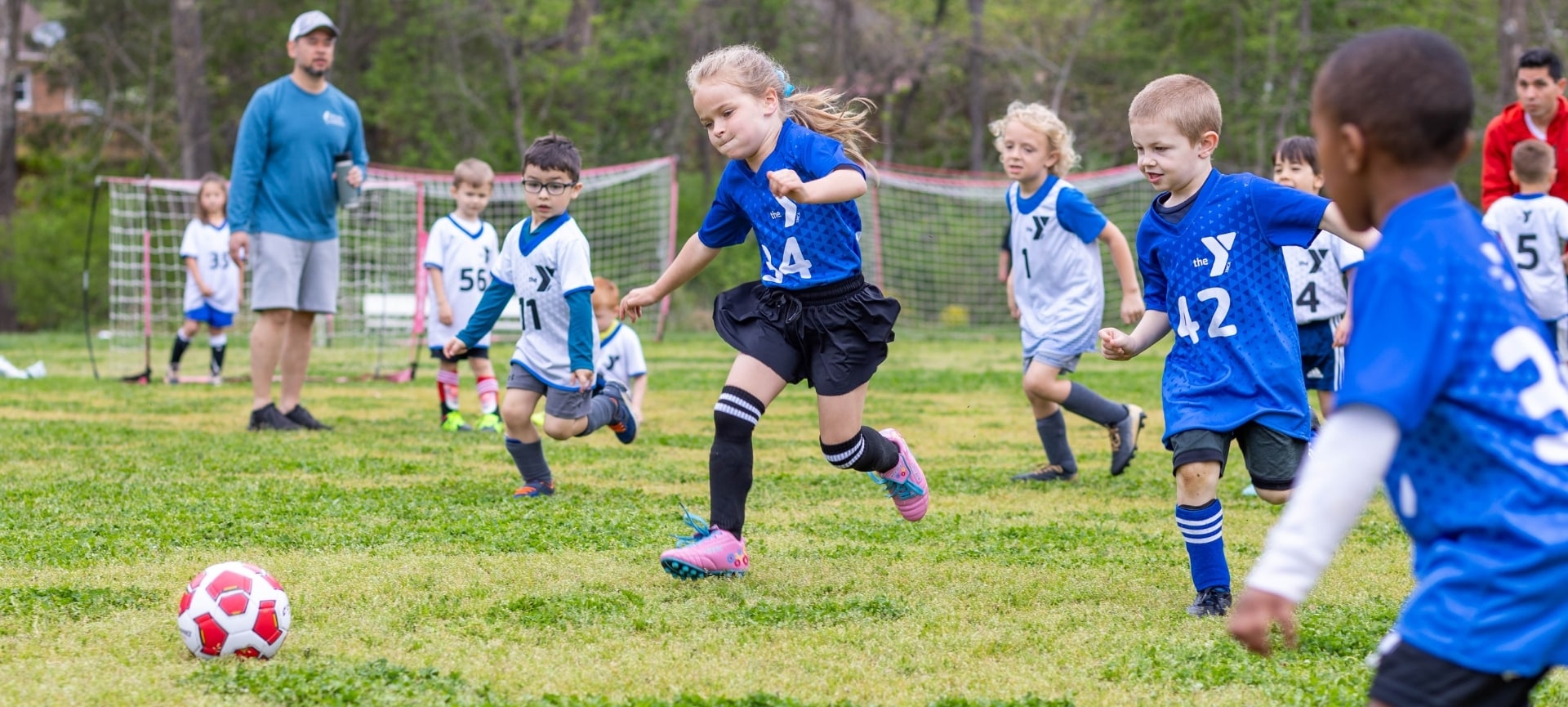 a group of kids playing soccer
