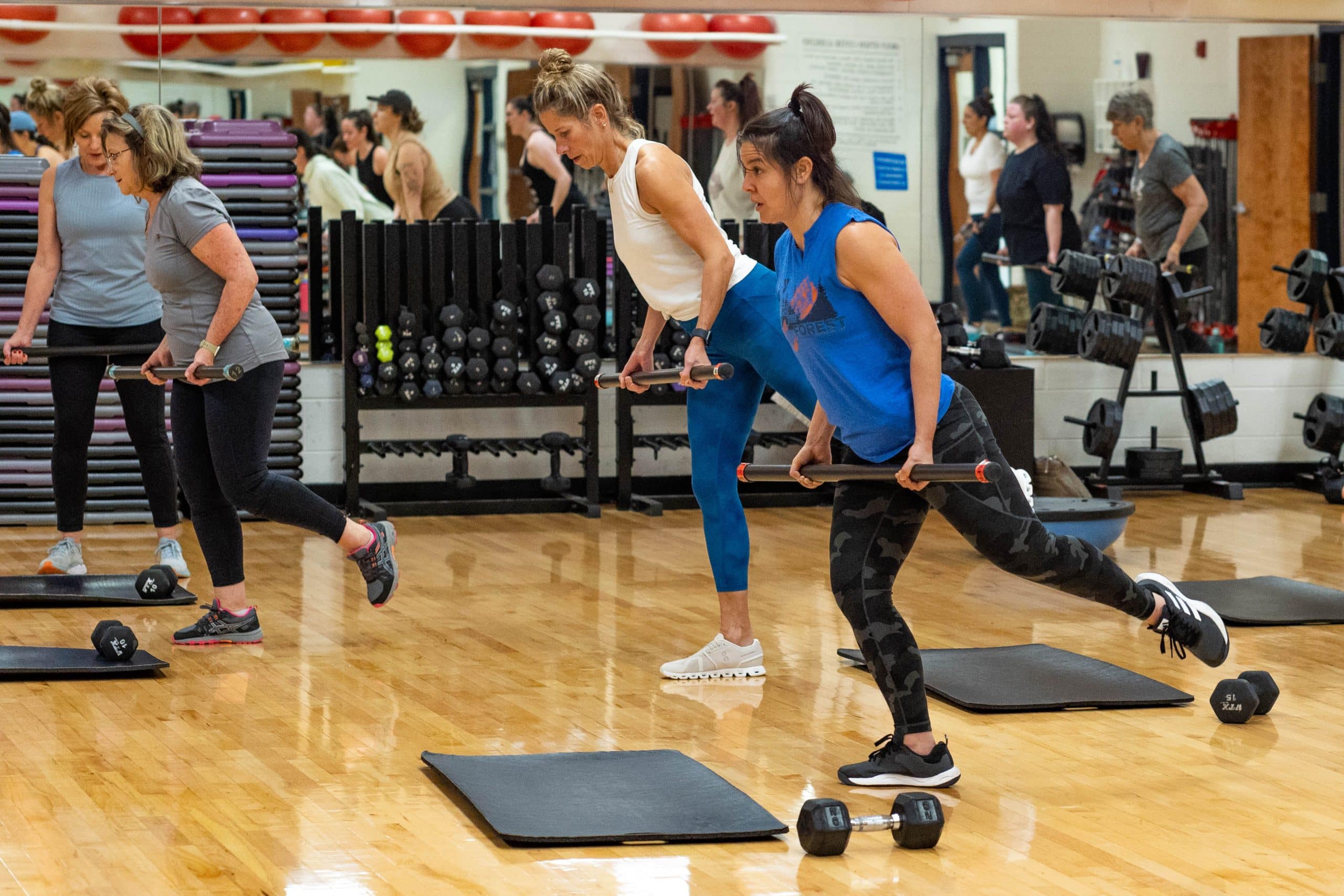 Group exercising with weights indoors.