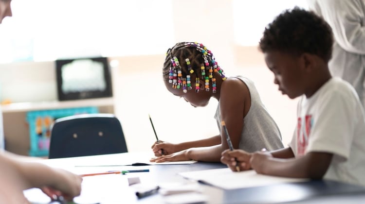 a group of children drawing on a table