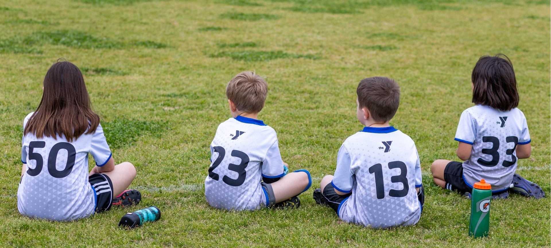 two boys sitting on the grass | fall and spring soccer