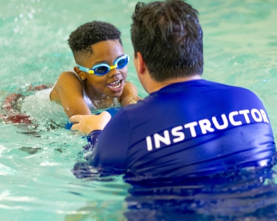 a man teaching a child how to swim | water safety