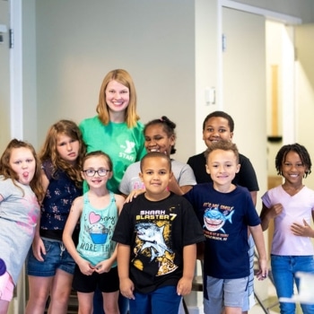 a group of children posing for a photo | choosing the ymca
