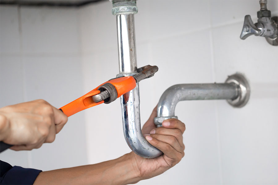 Plumber working under a sink