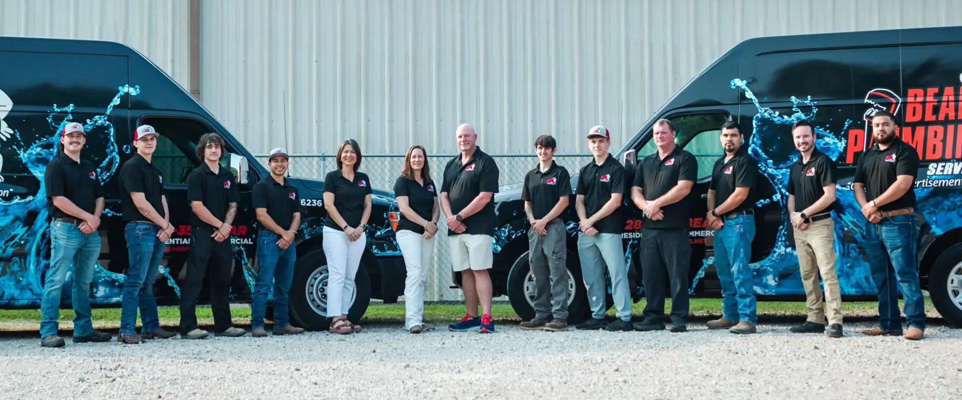Bear's Plumbing crew standing in front of branded service vans