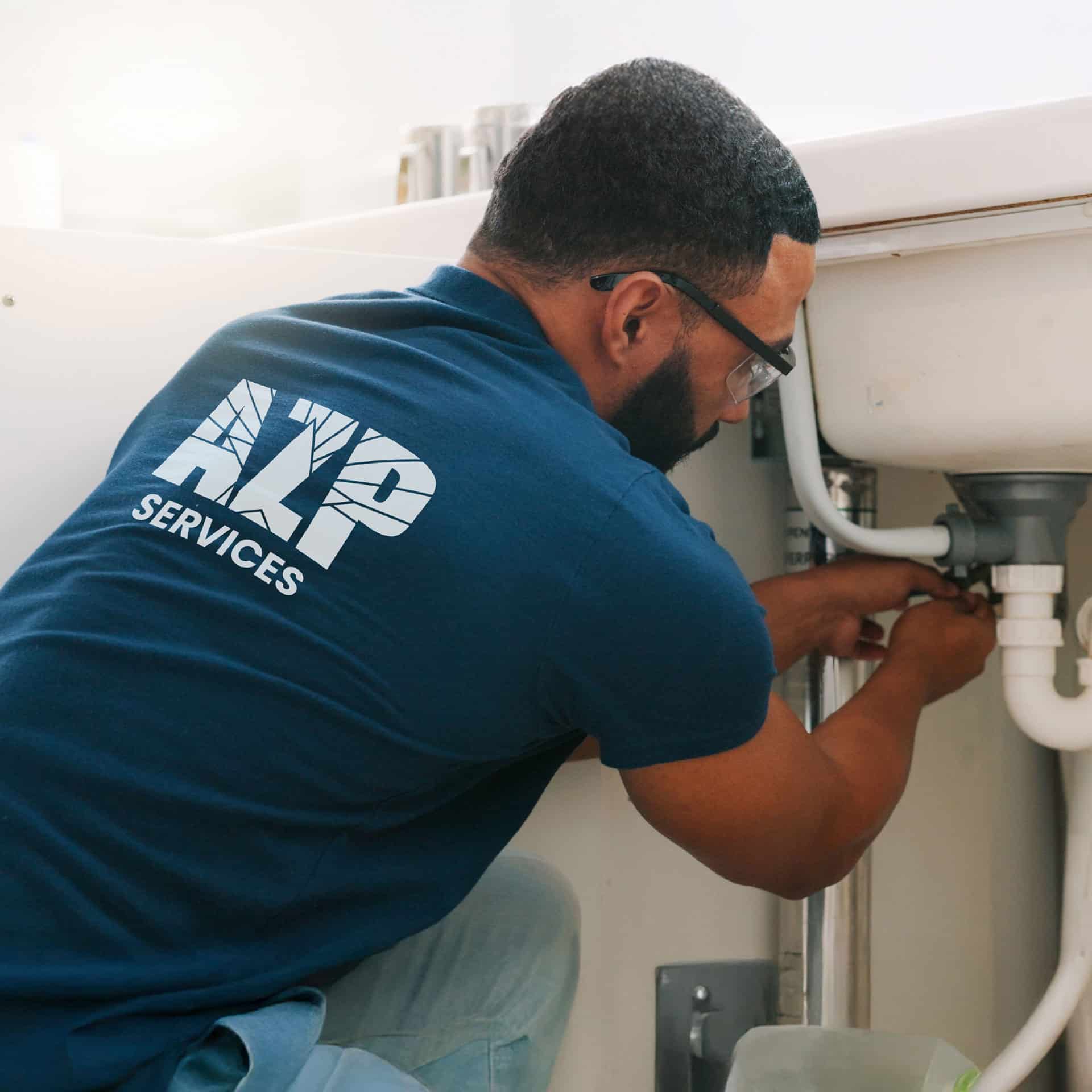 Technician repairing a sink