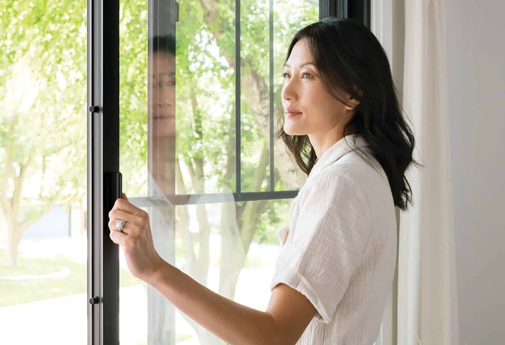 Homeowner beside a window